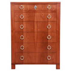 a wooden chest of drawers with metal handles