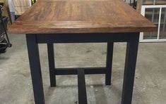 a wooden table with metal legs in a store