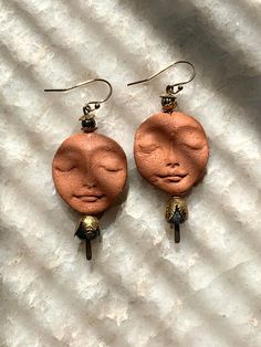 a pair of earrings that have been made out of copper