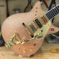 an electric guitar sitting on top of a wooden table