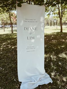 a welcome sign in the grass for a wedding