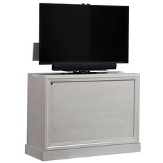 a flat screen tv sitting on top of a white cabinet