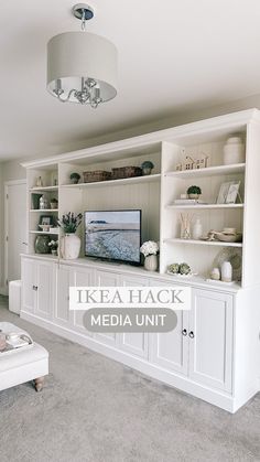 a living room filled with furniture and a flat screen tv on top of a white entertainment center