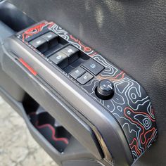 a close up of the control panel on a car's door handle and center console