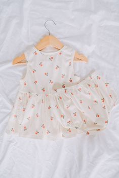 Upgrade your little one's wardrobe with this adorable Feel The Love Baby Dress & Shorts set. The tank top design is perfect for warm weather while the vibrant red flower pattern adds a touch of fun. Your baby will be the cutest and most stylish little love bug around! Cute Matching Set Tops For Vacation, Cute Summer Bloomers, Summer Cotton Sets With Strawberry Print, Cute Summer Sets For Playdate, Cute Summer Playdate Sets, Cute Bloomers For Playwear, Spring Season, Cute Bloomers For Spring Playwear, Fitted Cotton Bloomers For Playwear, Cotton Fitted Bloomers For Playwear