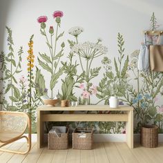 a room with flowers painted on the wall and baskets in front of it, next to a wooden bench