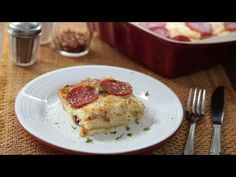 a slice of pizza sitting on top of a white plate next to a fork and knife