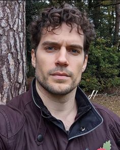 a man standing in front of a tree