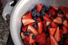 strawberries and blueberries in a silver bowl