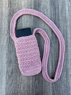 a pink cell phone case sitting on top of a wooden table