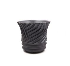 a black vase sitting on top of a white surface