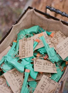 an open suitcase filled with lots of green and orange tags on top of each other