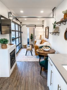 a living room filled with furniture and a flat screen tv mounted to the side of a wall