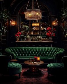 a living room with green couches and chandelier