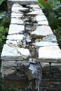 a stone wall with water running down it