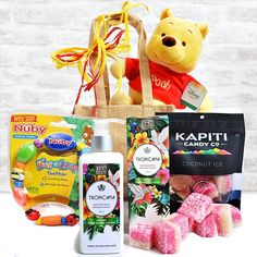 a winnie the pooh bear gift basket filled with candy and other items for kids