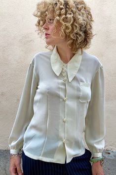 Vintage Matsuda White Shirt With Asymmetrical Collar in wonderful condition. This semi-sheer creamy button down is elegant with vintage flair. A timeless beauty. Comfortable and versatile. Made in Japan. dry clean only. 100% polyester. Best fits size S/M. Approx Measurements: Underarm to underarm: 17" across Length: 25" Vintage Unstructured Collared Tops, Classic Single-breasted Shirt With Spread Collar, Vintage Collared Cream Blouse, Vintage Collared Shirt With Abstract Print, 1970s Collared Shirt, Asymmetrical Collar, Pink Linen, Linen Top, White Shirt