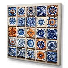 blue and orange tiles are arranged on a white wall in an artistic manner, with different designs