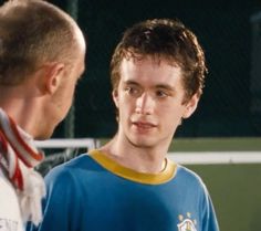 two men standing next to each other on a tennis court