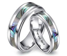 two wedding rings with abamole inlays on each side and the words love is