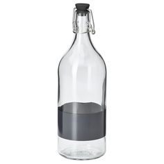 a glass bottle filled with liquid on top of a white table