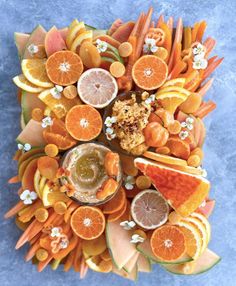 an arrangement of fruits and vegetables arranged in the shape of a star on top of each other