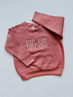 This sweet and simple embroidered big sis shirt is perfect for any little girl whether they are already a big sister or about to become one.  This cozy sibling sweatshirt features a brown text on an oatmeal sweatshirt or off white text on a pink sweatshirt!  This sweatshirt is the perfect combination of comfort, simplicity and cuteness! If you are interested in other colors and/or words, send me a message and we can find something that meets your needs!   Looking for coordinating big bro sweatshirt?  Check out our other sibling shirts in the "Kids Clothing" tab in our shop!  Details: This sweatshirt is a 60/40 cotton/polyester blend Thread is polyester Embroidery Wash and Care: -Always wash your garment before use -Wash inside out with mild detergent -Wash on cold, gentle cycle -Do not use New Big Sister, Sibling Announcement, Big Brother Shirt, Sibling Shirts, Sister Shirt, Brother Shirts, Big Sister Shirt, Big Sis, Sister Shirts