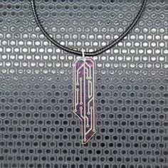 For the discerning Corpo, this iridescent piece is an elegant non-UV reactive rendition of our classic Data Chip Necklace. They are laser cut and engraved on a mesmerizing iridescent acrylic. This acrylic radiates a captivating array of colors--pink, yellow, purple, green, and sometimes blue--creating a dynamic visual display that evolves with the changing light. Key Features: Exclusive custom design Laser cut and engraved Shifting colors in natural light Specifications: Material: Special clear iridescent cast acrylic Length: 2 1/4 inches Necklace: 17-19 inch adjustable cotton cord & ball chain necklace Combine this necklace with a matching set of Data Chip Earrings at a discounted price. Cyberpunk Necklace, Tech Necklace, Futuristic Necklace, Cyberpunk Jewelry, Cyberpunk Accessories, Futuristic Jewelry, Iridescent Acrylic, Chip Necklace, Tech Jewelry