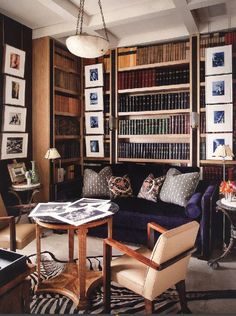 a living room filled with furniture and lots of books