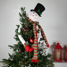 a christmas tree with a snowman decoration on it