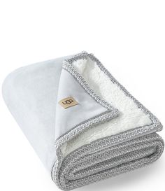 From UGG&#x2C; this throw features:Richly quilted&#x2C; it's edged with an intricate braid that adds sleek dimensionSoft and cozyAuthentic UGG® logo labelApprox. 50" x 70"Weight approx. 5 lbs. Polyester&#x2C; spandex Machine wash cold&#x2C; gentle cycle&#x2C; do not bleach&#x2C; tumble dry lowImported. Decorative Throws Blanket, Bedroom Deco, Grey Throw, Decorative Throws, Fashion Editor, Dillard's, Christmas Wishlist, Lifestyle Brands, Nike