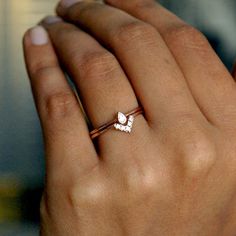 a woman's hand with a diamond ring on it