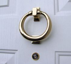 a close up of a door handle on a white door