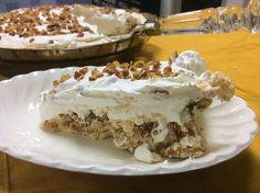 a piece of cake sitting on top of a white plate next to a pie pan