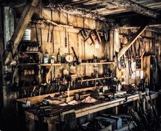 an old workshop with lots of tools on the table and shelves full of woodworking equipment