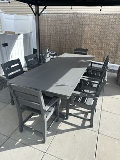 an outdoor table and chairs are set up on the patio