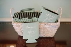 a basket filled with lots of cards next to a couple's names on top of each other