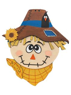 a wooden cutout of a scarecrow wearing a brown hat with a sunflower on it's forehead