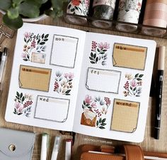 an open planner book sitting on top of a wooden table