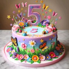 a birthday cake with flowers and butterflies on it's top is the number five