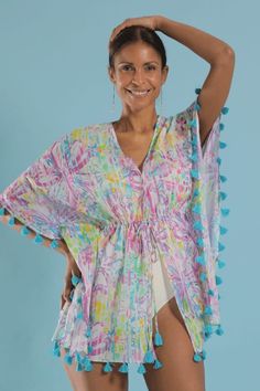 Stylish and easy to wear coverup. A playful flower print with purples and pops of lime on white. Turquoise tassels. Drawstring waist. This elegant and modern caftan works as beachwear, loungewear, or layered over a camisole for a casual look. Tie it open for a kimono style. White Turquoise, Kimono Style, Kimono Fashion, Flower Print, Palm Beach, Flower Prints, Drawstring Waist, Casual Looks, Tassels