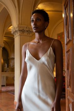 Stunning floor length bias cut gown with deep v-neck and spaghetti straps in a rich, fluid-like alabaster silk charmeuse. Erica Tanov Details Made in USA. 100% Silk. Dry clean only. Charmeuse Gown, Erica Tanov, Silk Camisole, Silk Slip Dress, Silk Slip, Silk Charmeuse, Deep V Neck, Floor Length, Spaghetti Strap