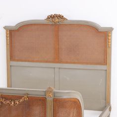 an antique bed with wicker headboard and foot board