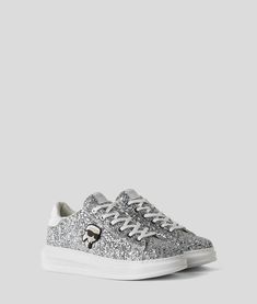 Silver Casual Sneakers With Metallic Logo, Streetwear Sneakers With White Sole And Metallic Logo, Low-top Textile Sneakers With Embroidered Logo, Silver Low-top Sneakers With Textured Sole, Silver Sneakers For Streetwear With Speckled Midsole, Silver Sneakers With Speckled Midsole For Streetwear, High-top Textile Sneakers With Embroidered Logo, Casual Sneakers With Metallic Logo For Streetwear, Casual White Sneakers With Foil Embossed Logo