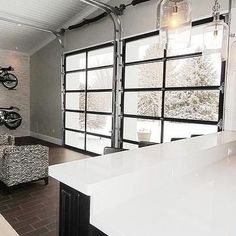 a living room filled with furniture and a bike mounted to the wall next to a window