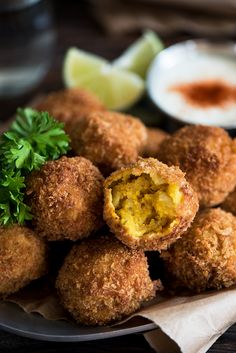 some fried food on a plate with dipping sauce