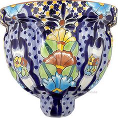 a blue and white vase with flowers painted on it