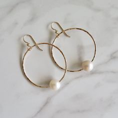 Gold Hoop Pearl Earrings~ These elegant gold hoop earrings with a freshwater white pearl will look great for any occasion. Hammered and polished to a beautiful shine. Hoops are approx. 1.5" Model wearing similar design~ https://www.etsy.com/listing/111095394/white-pearl-earrings-gold-hammered-hoops?ref=shop_home_active_22 Shop~ http://www.etsy.com/shop/HanaMauiCreations?ref=pr_shop_more International buyers please read our shipping policies before ordering~ POLICIES~ https://www.etsy.com/shop/Ha Handmade Yellow Gold Pearl Hoop Earrings, Elegant Handmade Pearl Hoop Earrings, Handmade Pearl Yellow Gold Hoop Earrings, 14k Gold-filled Small Hoop Pearl Earrings For Wedding, Elegant 14k Gold-filled Pearl White Pearl Earrings, Hammered Hoop Earrings, White Pearl Earring, Victorian Gold, Gold Pearl Earrings