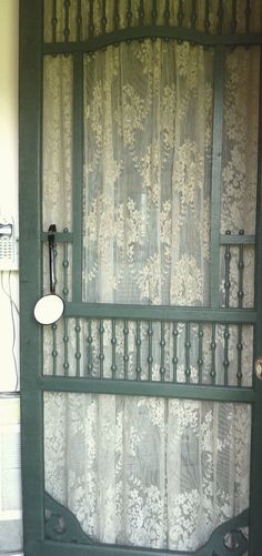 a green door with white lace on it