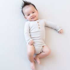 This long sleeve bodysuit is made from soft, stretchy ribbed bamboo that keeps your little one comfortably warm without being too hot. A henley neckline with wooden buttons adds a special touch for a casually cool look. 97% Rayon made from Bamboo, 3% Spandex Ribbed fabric Henley neckline Wooden buttons Inseam snap closure Cream Long Sleeve Bodysuit For Loungewear, Henley Outfit, Womens Matching Sets, Bag Hanger, Toddler Blanket, Family Pajamas, Wooden Buttons, Long Sleeve Pyjamas, Long Sleeve Bodysuit